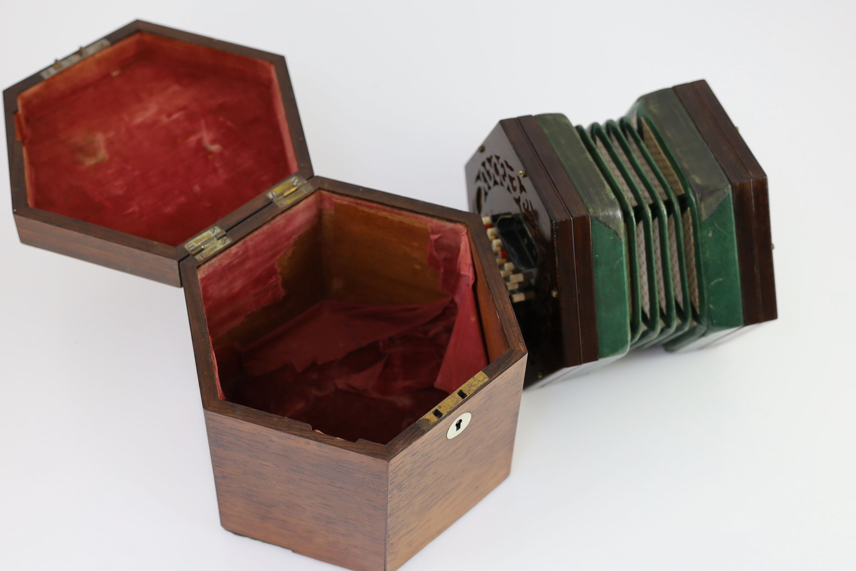 A 48-key C. Wheatstone English model rosewood concertina, diameter 18cm, housed in the original rosewood case